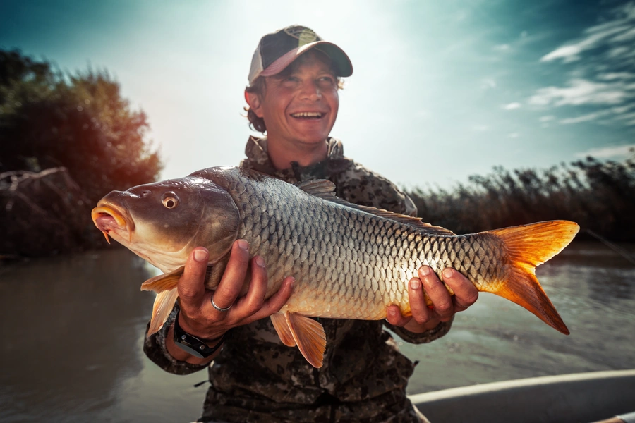 Fisherman Holding a Carp